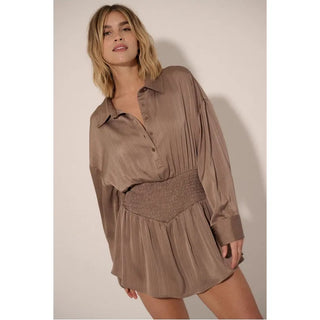 A satin-stripe, romper with the following features:
Collared neckline.
Half button front closure.
Long sleeves with button cuffs.
Dropped shoulder.
Smocked waist.
Lined.
Yoke back.
Relaxed fit.