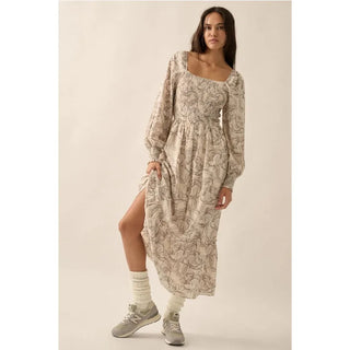 A floral print woven midi dress with the following features:
Square neckline.
Long sleeves with smocked cuffs.
Smocked bodice.
Thigh length lining.
Calf length.
Fit and flare