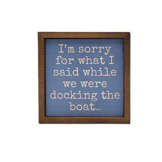 Framed text sign with humorous quote on a blue background