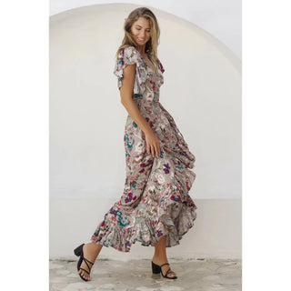 Wrap yourself in luxury in our Carmen Wrap Maxi Dress. Crafted from super soft rayon fabric, this dress elegantly flatters with its leg-loving split, frilled hem, and self-fabric tie at the waist. 