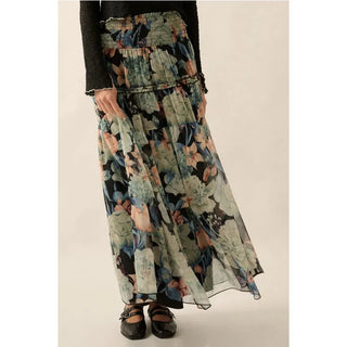 A floral print woven maxi skirt with the following features:
Semi-sheer fabric.
Smocked yoke waist.
Tiered ruffle skirt with trim.
Lined.
Ankle length.
Relaxed fit.