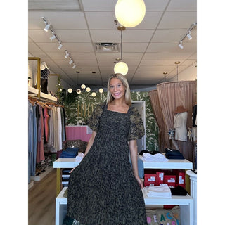 Maxi dress with ruched bodice and subtle leopard print, complemented by embroidered floral puff sleeves. Fashionable and elegant women's attire for any occasion.