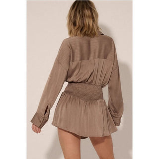 A satin-stripe, romper with the following features:
Collared neckline.
Half button front closure.
Long sleeves with button cuffs.
Dropped shoulder.
Smocked waist.
Lined.
Yoke back.
Relaxed fit.