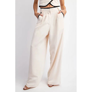 contrast cream trousers with contrast black stitch