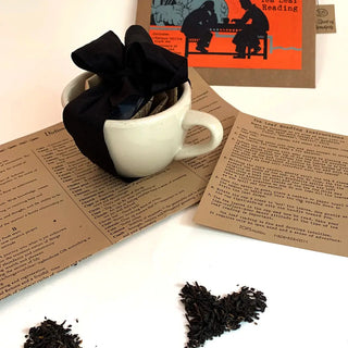 Tea Leaf Reading Kit with Tea Cup includes a brief history, instructions, dictionary of symbols, and a bag of loose tea. 